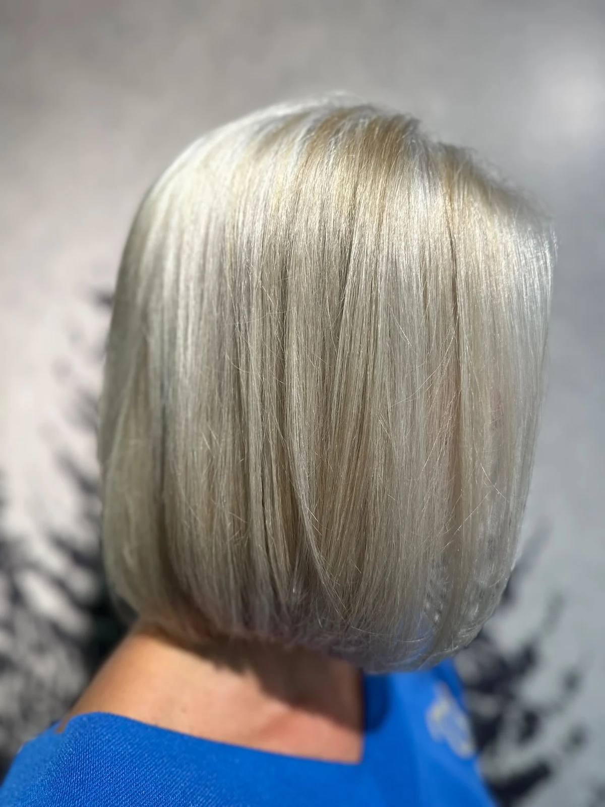 Celines Grey-Blending-Ergebnis von der Seite: heller Bob mit feinen grauen und blonden Farbnuancen.
